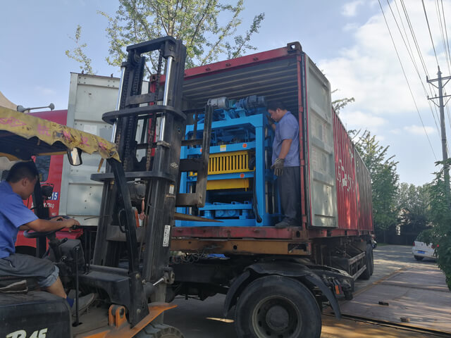 Loading QT4-25 block machine into container for shippment